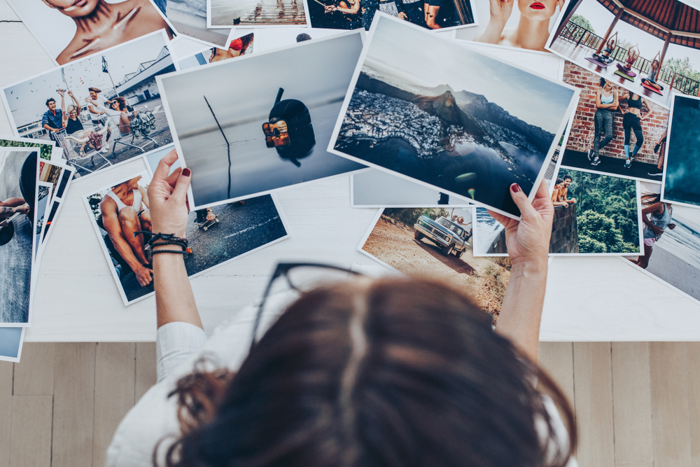 top view of a woman looking at photo prints