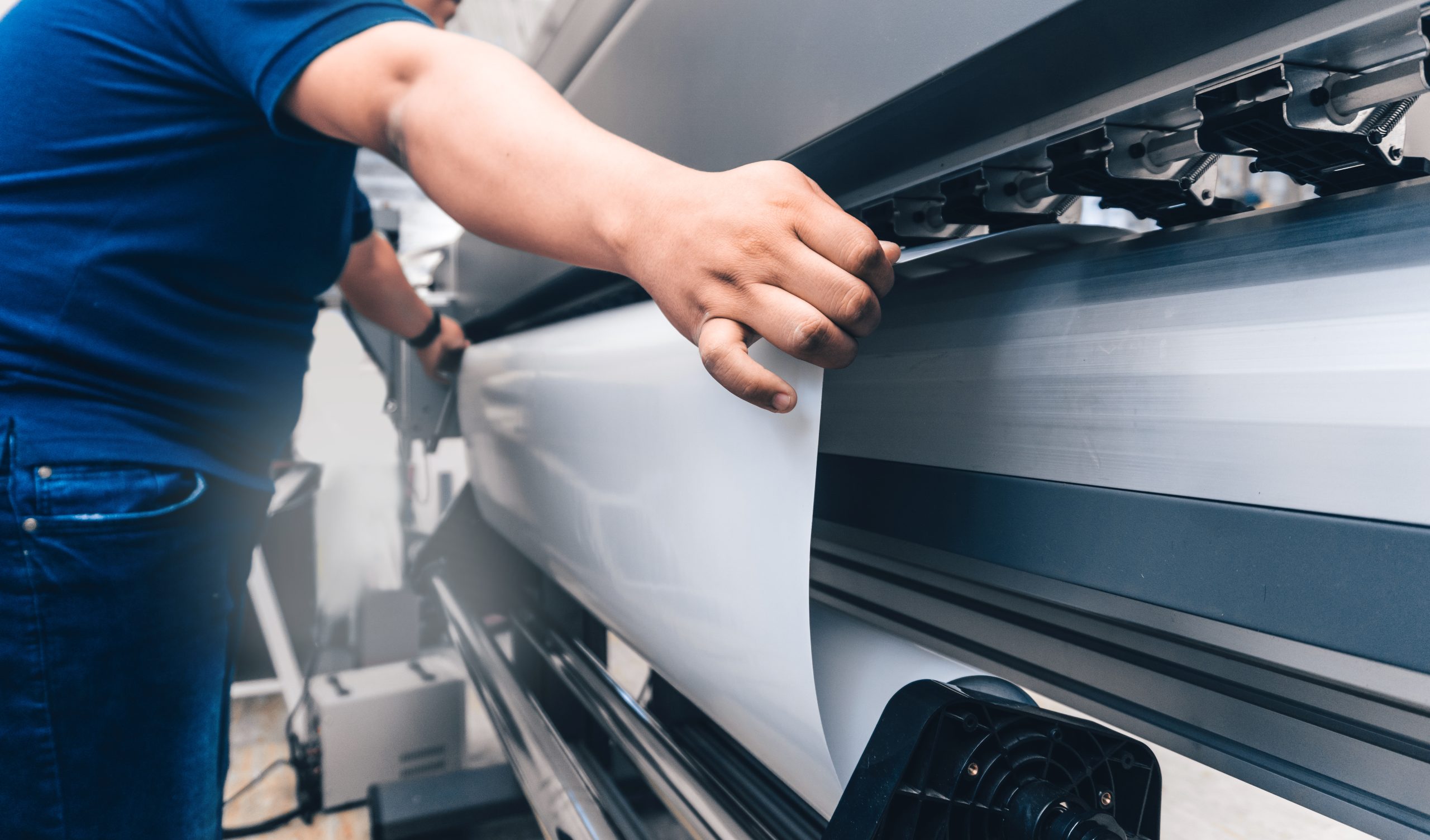 Large format banner being printed on a wide format printer at Expresscopy