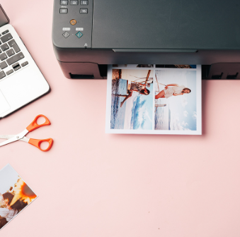 Photo prints coming out of a printer for personalised gifts at Expresscopy